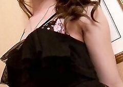 See a sizzling sexy Oriental trans woman lying on white sheets, pulling aside her ebony pants to expose her shlong and balls whilst teasing herself wi